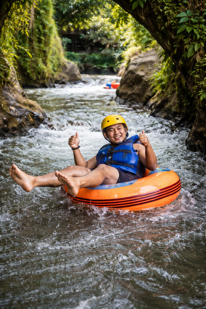 Cave tubing adventure in Ubud Bali with a tourist floating on a river surrounded by tropical jungle